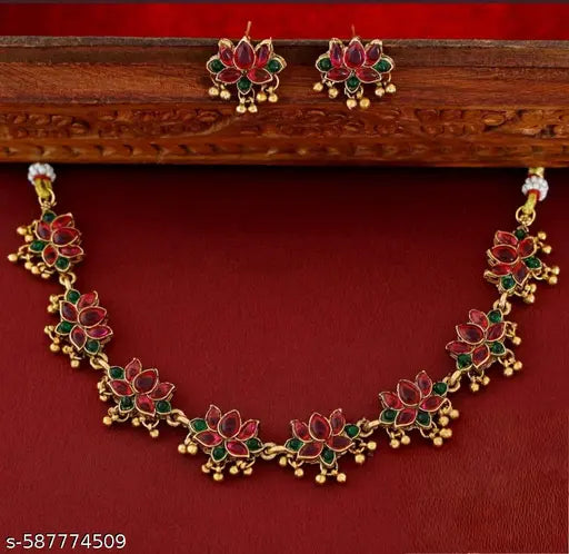 Grace your festive and traditional looks with this stunning lotus-inspired necklace set. Designed with intricately crafted red and green lotus motifs outlined in gold